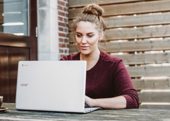 Woman uses laptop for online mental health elearning